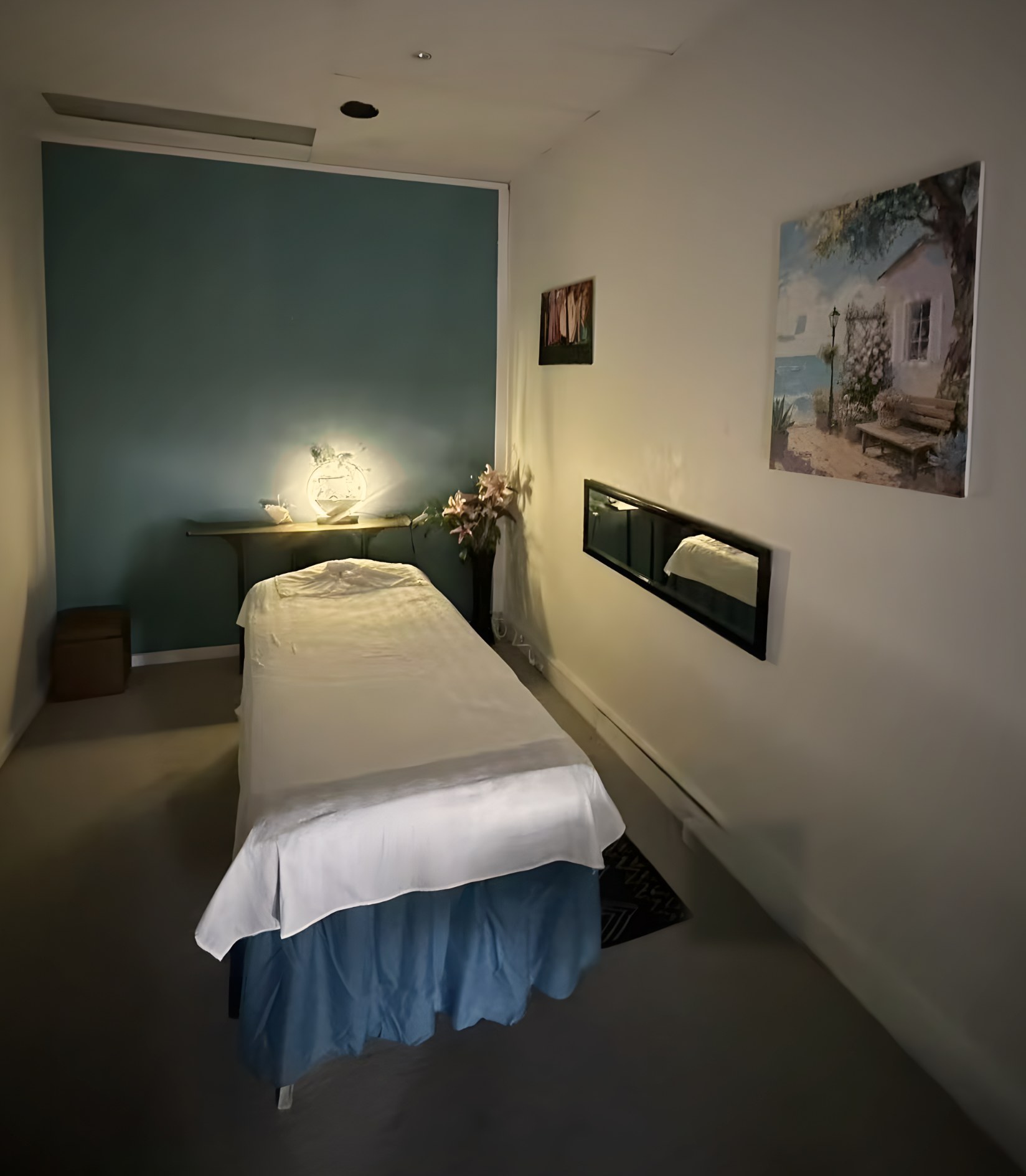 Massage room at Ocean Retreat Massage in Glen Waverley, with a softly lit lamp and fresh white linen